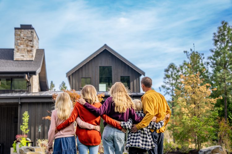 Family Hugging Facing Modern House Inti St Clair Austin Texas Tumble Creek Scene Backyard Working