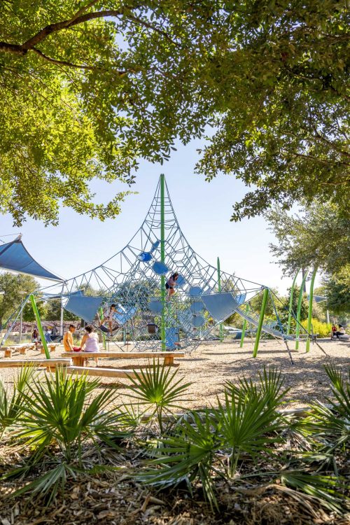Children Playing in Park surrounded by landscape