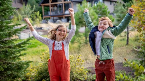 Excited Kids Jumping Outside Tumble Creek
