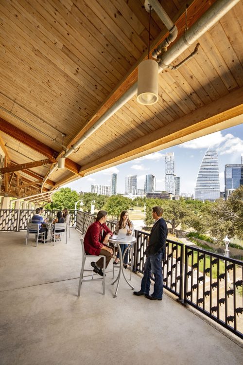Friends on Balcony with Austin Skyline