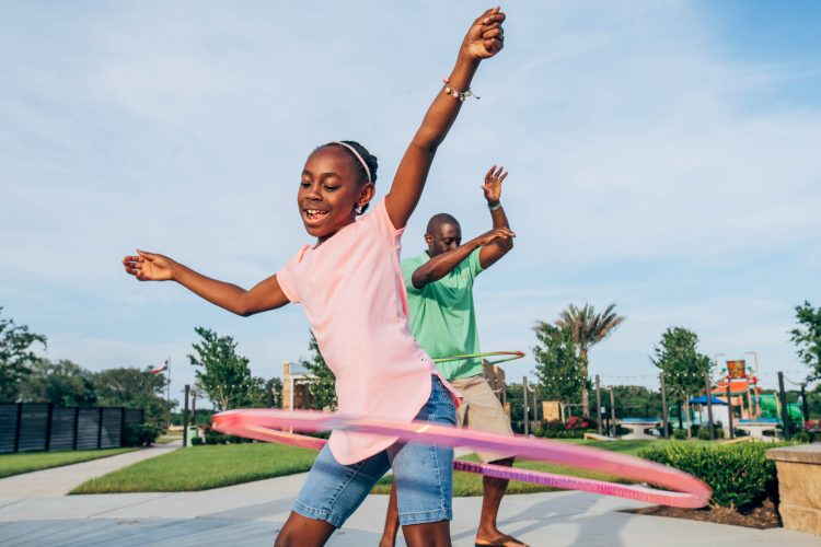 Dad and DaughterHula Hooping in the Park