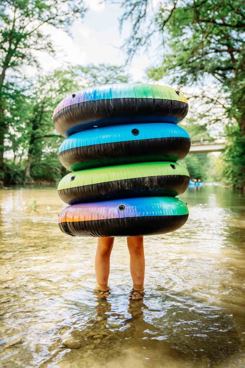 Girl Holding Inner Tubes Over Body