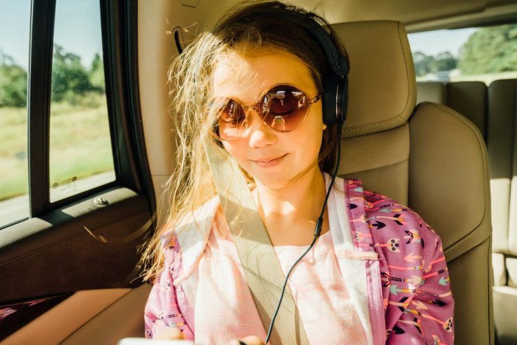 Girl Listening to Music in Car on Headphones