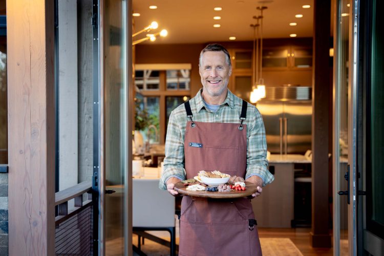 Man Holding Appetizers in Kitchen Doorway
