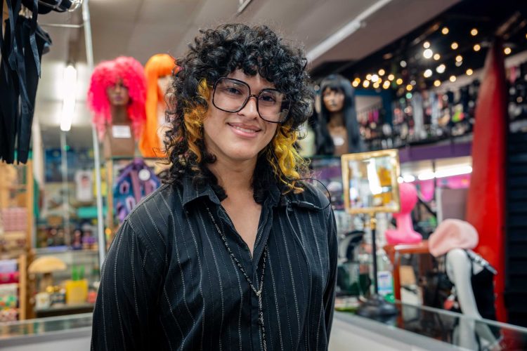 Smiling person in wig store