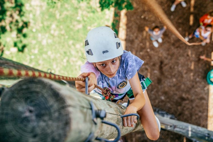 Teen Girl Climbing Pole