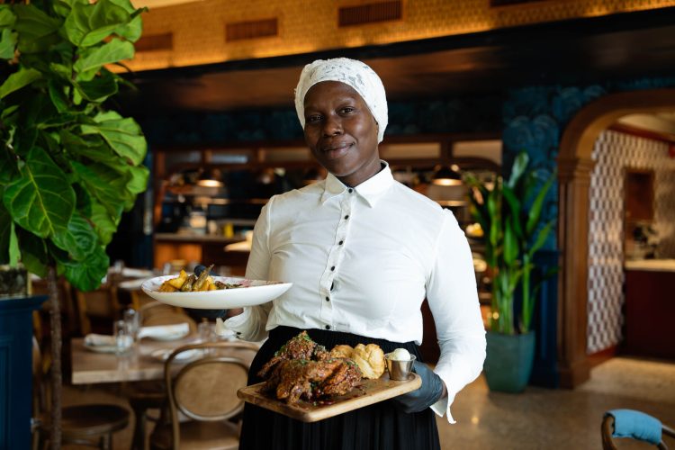 Woman Holding Food in Restaurant
