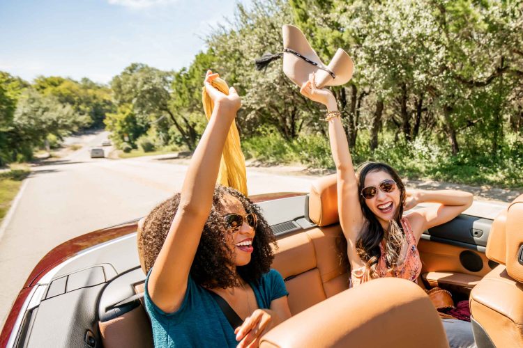Women Celebrating in Convertible