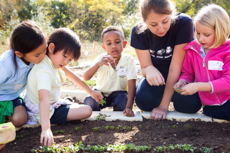 kids and teacher learning in garden