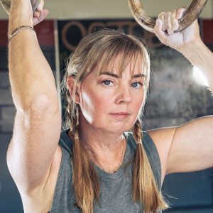 blonde woman braids chalked hands rings
