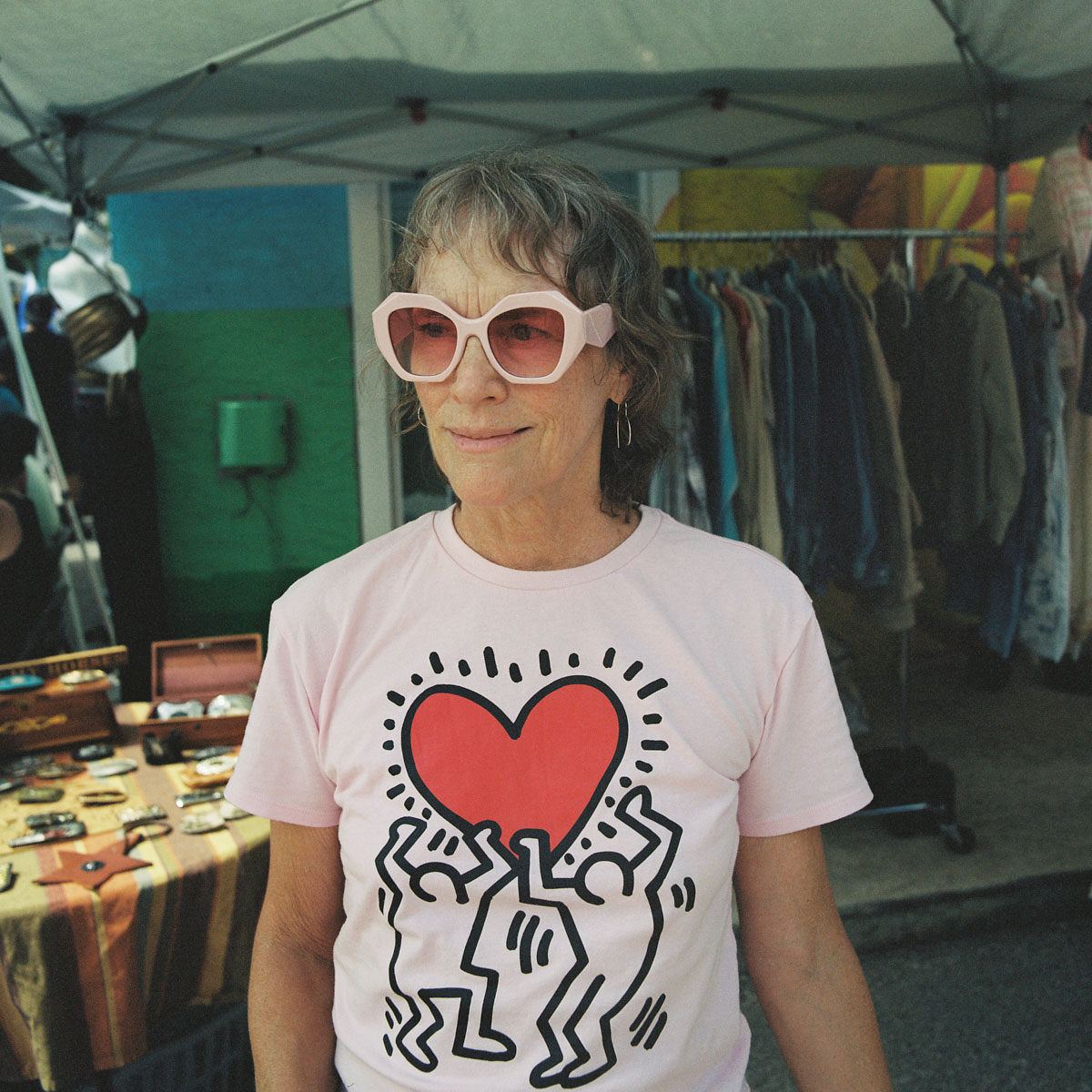 elder woman sunglasses keith haring shirt