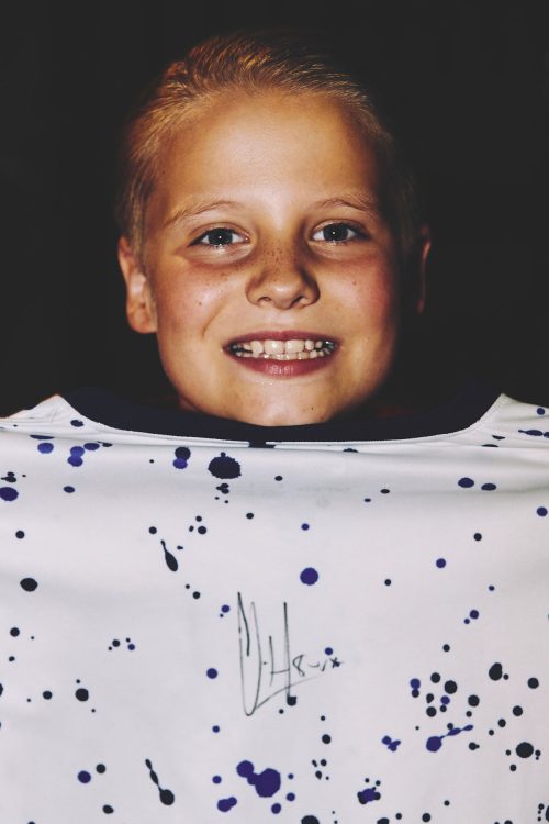 kid holding autographed jersey austin