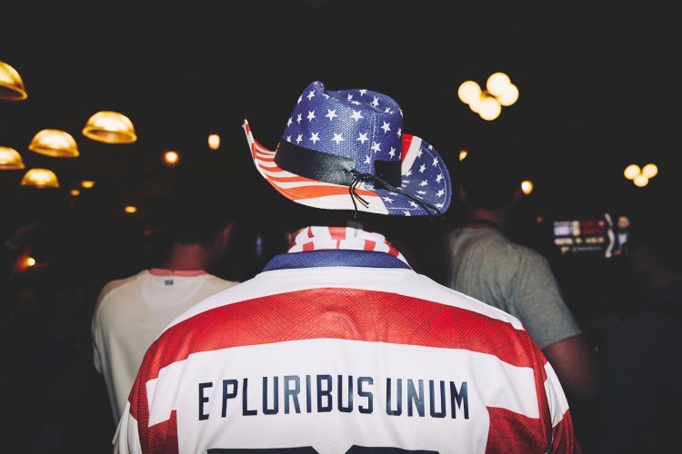 man wearing e pluribus unum jacket cowboy hat