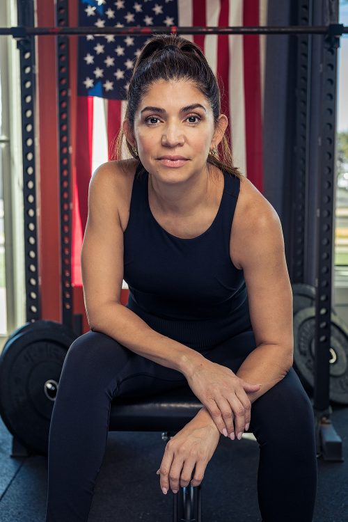 woman crossfit athlete benchpress usa flag
