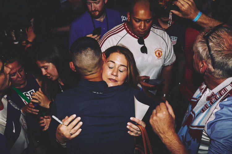 woman hugging eyes closed crowd austin