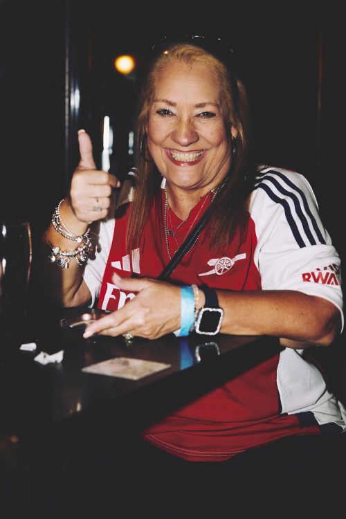 woman thumbs up arsenal jersey austin